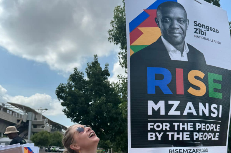 A RISE Mzansi member hanging a poster. Facebook/RISE Mzansi