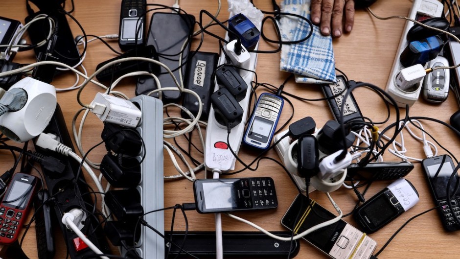 File: Cellphones being charged. AFP/Ronaldo Schemidt