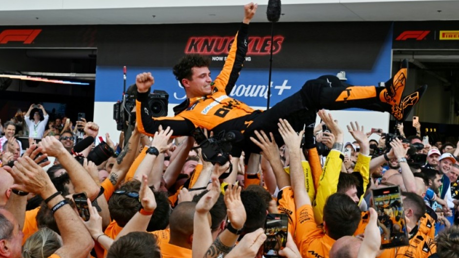 McLaren's Lando Norris is tossed in the air as his team celebrates victory at the Miami Grand Prix on Sunday