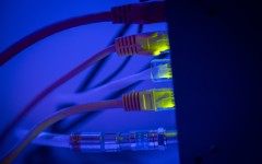 Ethernet cable wires lighting up connected to an internet router modem. Jaap Arriens/NurPhoto via AFP