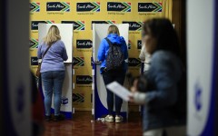 People mark their ballot papers as they vote in the South African general election, at the South African High Commission in central London. AFP/Benjamin Cremel