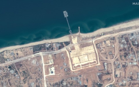 A handout satellite image courtesy of Maxar Technologies shows the US-built Trident Pier on the Gaza coast lined up nearby