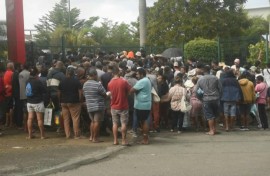 People queue outside a supermarket in New Caledonia's Noumea