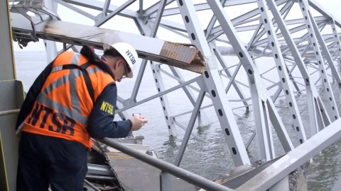 This handout screengrab from the National Transportation Safety Board, shows investigators aboard the cargo ship Dali inspecting hazardous materials and part of the steel frame of the Francis Scott Key Bridge in Baltimore, Maryland on March 28, 2024