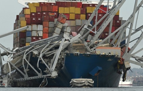 The steel frame of the Francis Scott Key Bridge sits on top of the container ship Dali after the bridge collapsed in Baltimore, Maryland, on March 26, 2024