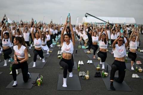 The unusual event on the airport's third runway saw the workout paired with beverages as participants were offered coconuts, iced teas and water to incorporate into their routines
