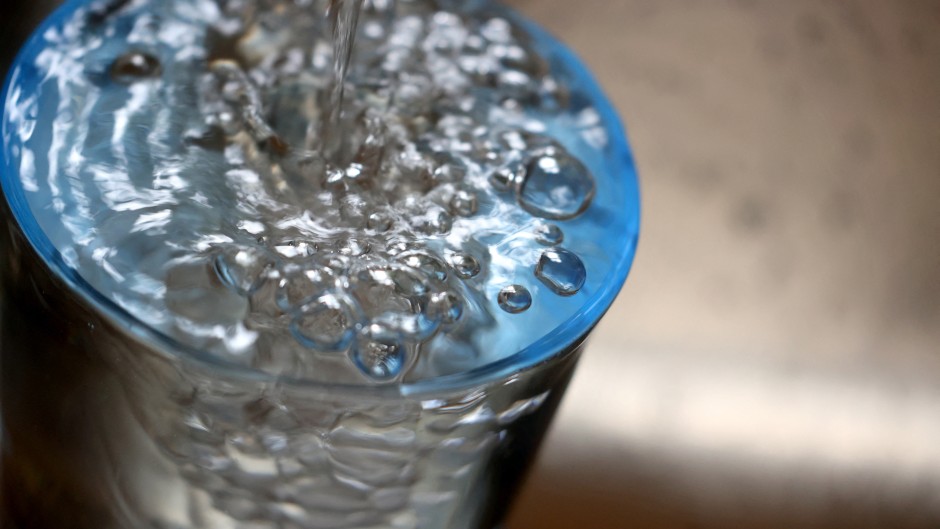 File:  Tap water flows into a glass.  
