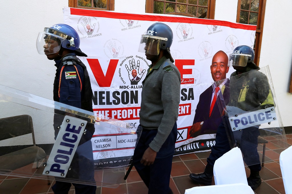 Riot police arrive at a press conference due to be addressed by opposition Movement for Democratic Change (MDC) leader Nelson Chamisa, ordering journalist out of the venue in Harare, Zimbabwe, 3 August 2018.