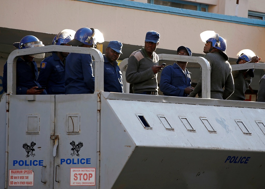 Police in vehicles patrol the area a day after the clashes between security forces and opposition protesters in Harare, Zimbabwe, August 2, 2018. 