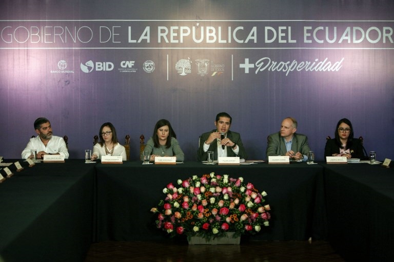 Ecuador's Economy Minister Richard Martinez (C) offers a press conference, along with other government representatives. 