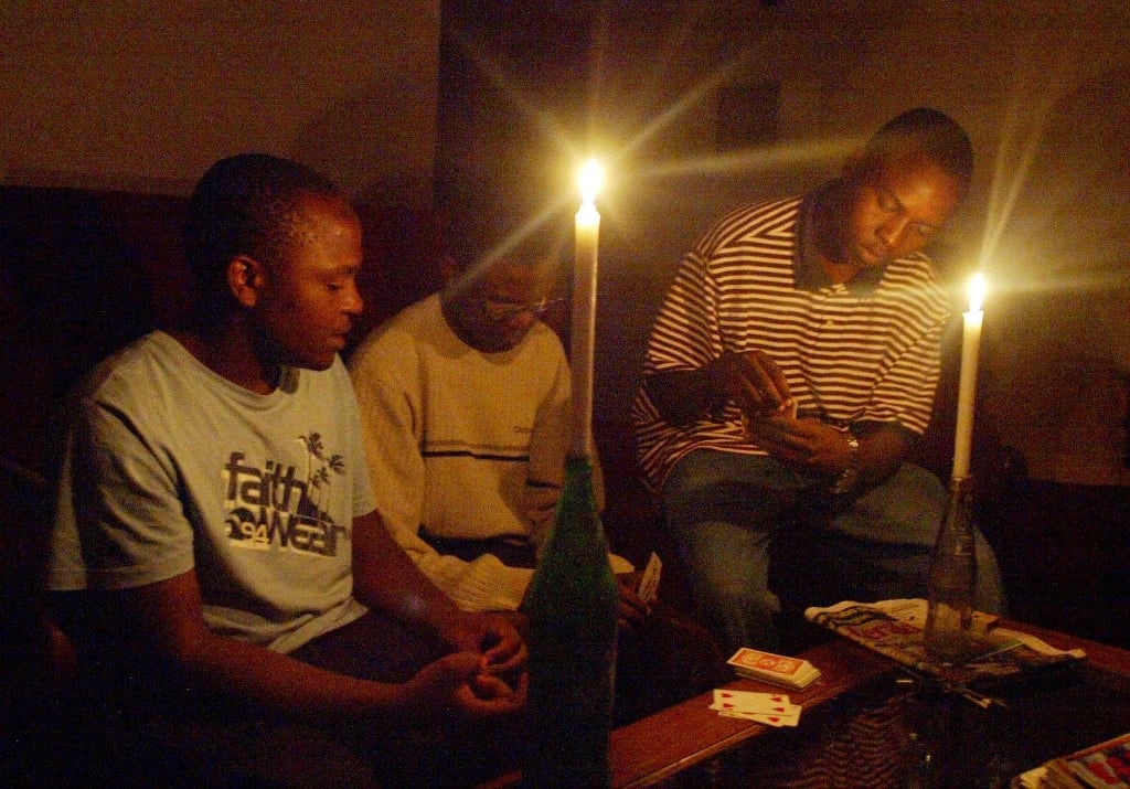 A Zimbabwean family plays card in Harare after the second power cut, which has hit most parts of the country.