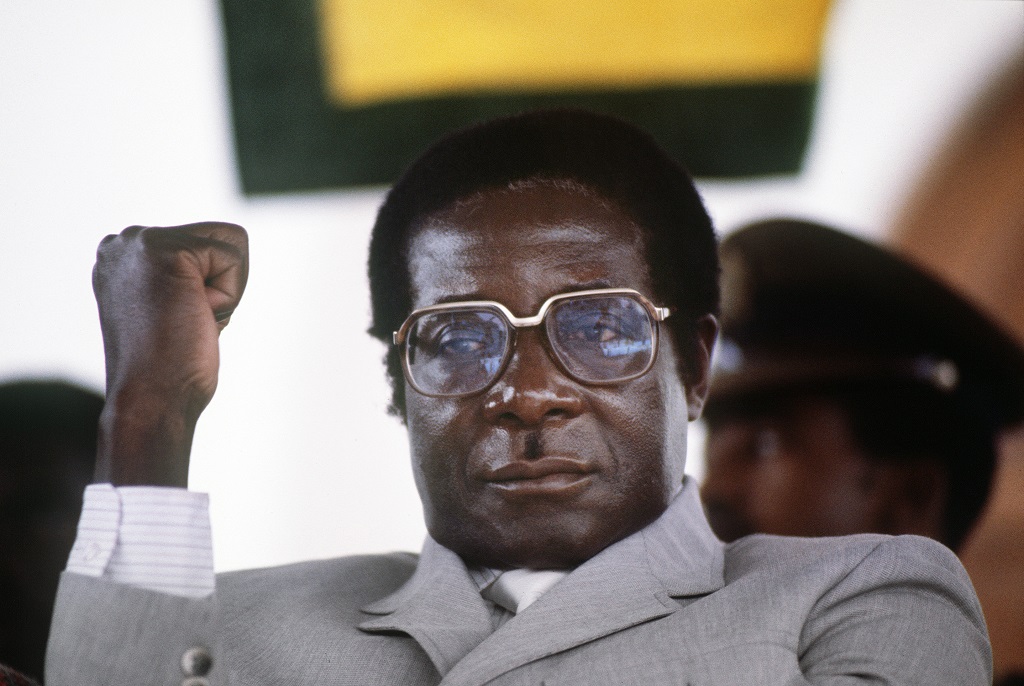 Zimbabwe's Prime Minister Robert Mugabe clenches his fist, in July 1984 in Harare stadium during a meeting. 