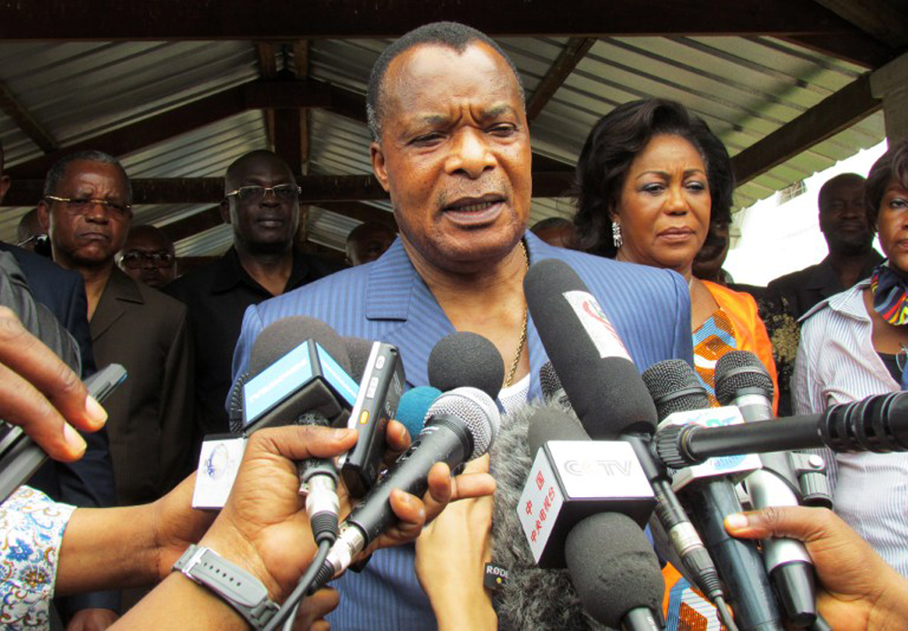 Congolese President Denis Sassou Nguessou talks to the media after voting o...