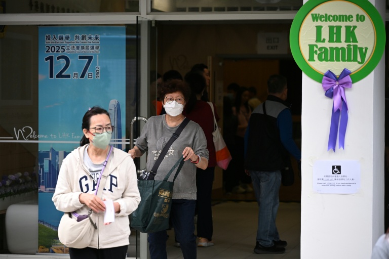Residents exit a polling station in Tai Po district during the Legislative Council elections in Hong Kong on December 7, 2025.