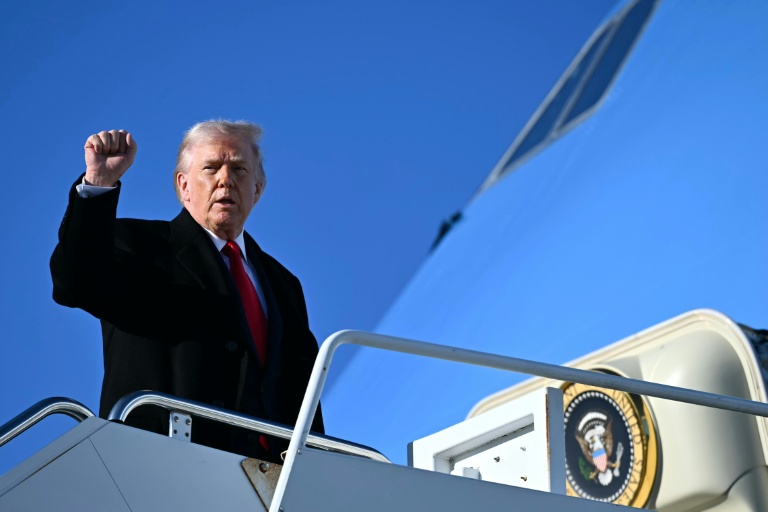 US President Donald Trump gestures as he boards Air Force One at Fort Bragg, North Carolina