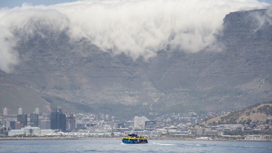 File: A ferry, with Table Mountain and part of the city in view, takes visitors back to the mainland after a tour of Robben Island.