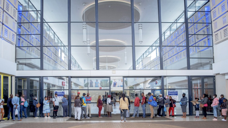 Shoppers queue to enter the Jabulani Mall in Soweto.