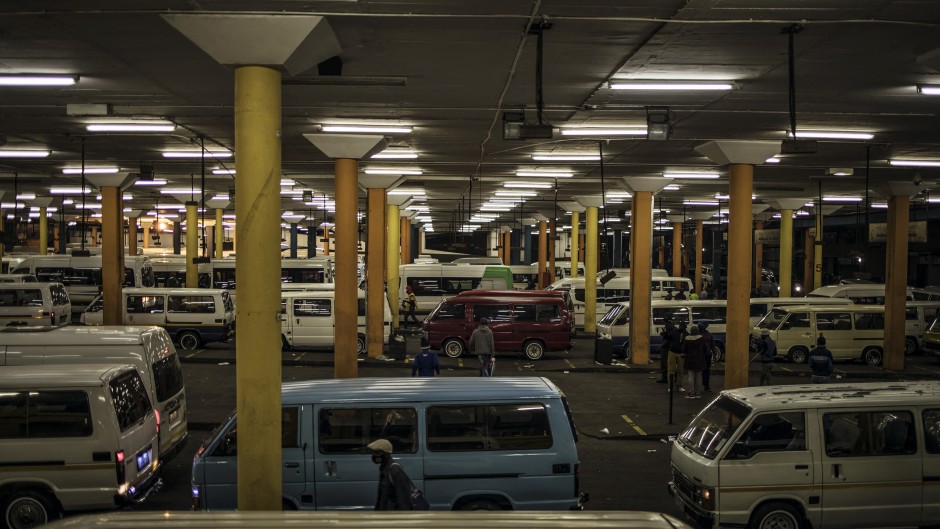 File: Commuters arrive at the Noord taxi rank in Johannesburg, on June 1, 2020. MARCO LONGARI / AFP