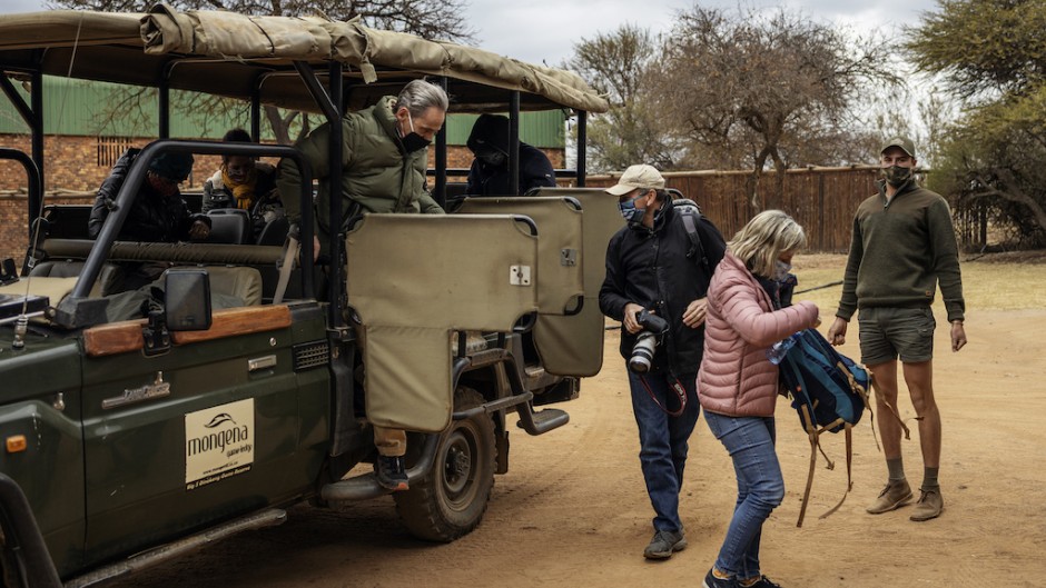 Tourists wearing face masks as a preventive measure against the spread of COVID-19 coronavirus get off from an open vehicle during a guided safari tour at the Dinokeng Game Reserve outside Pretoria, on 7 August 2020. 