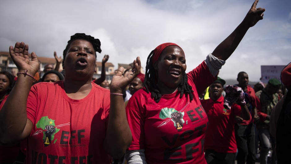 Supporters of the Economic Freedom Fighters (EFF) gesture as they march through the centre in Cape Town on March 20, 2023.