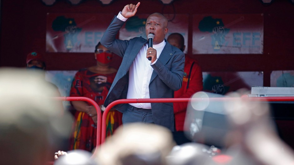 Economic Freedom Fighters (EFF) leader Julius Malema addresses his supporters outside the Randburg Magistrate Court, near Johannesburg, on October 13, 2020. 