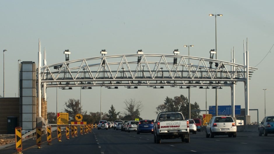 File: South African motorists drive towards the electronic toll plaza on the highway from Pretoria to Johannesburg. ALEXANDER JOE / AFP
