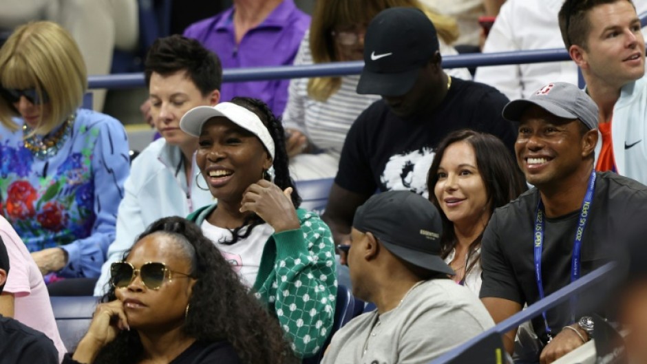 Super fan: Tiger Woods (right) watches the match with Venus Williams