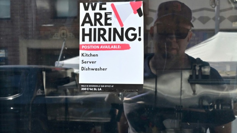 A 'We Are Hiring' sign is seen in front of a restaurant in Los Angeles, California in August 2022