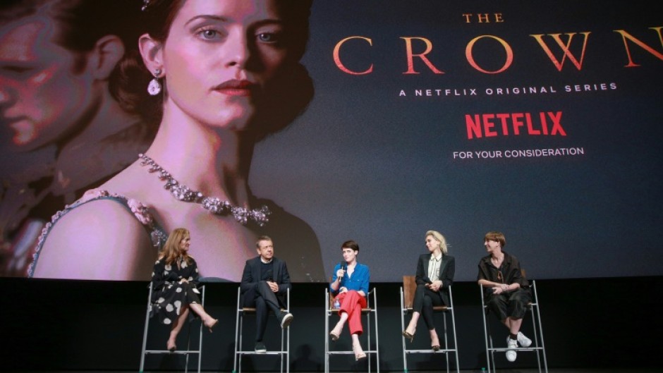 Cast members of the first season of Netflix's The Crown, including Claire Foy, who portrayed a young Queen Elizabeth II, are seen in 2018. Netflix says it has suspended filming on the show's latest season out of resepect for the late monarch 