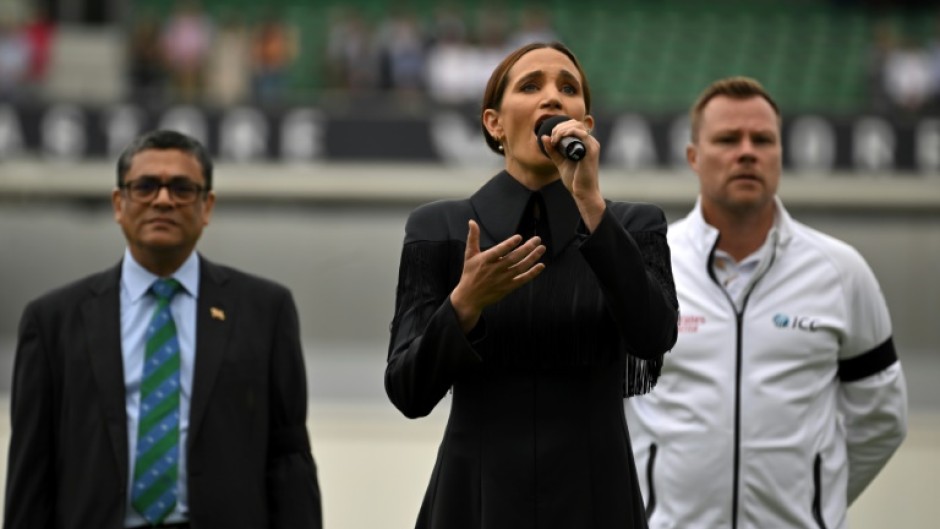 Laura Wright (C) sings ' God Save the King' at the Oval on Saturday
