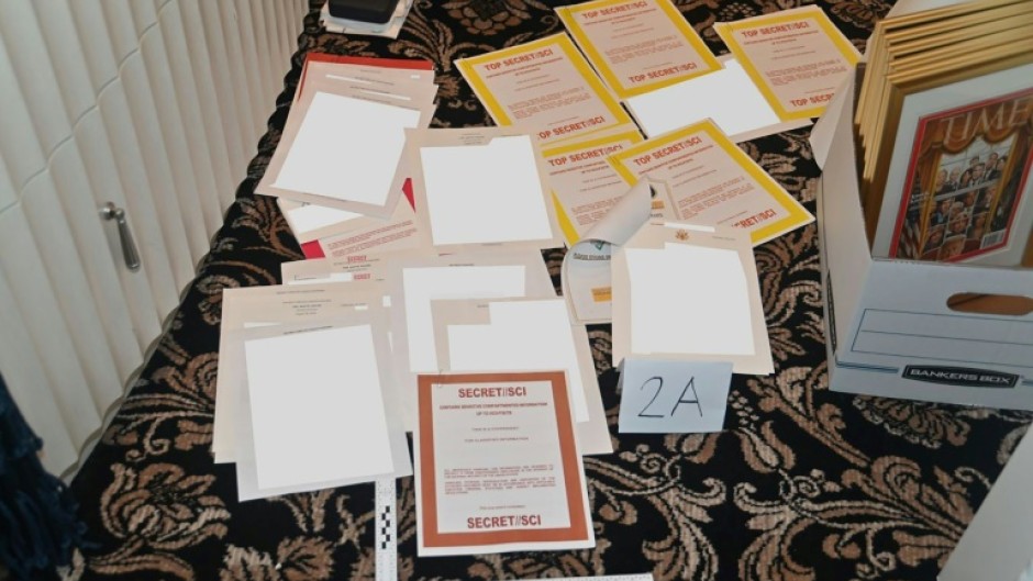 This undated file photo released by the US Department of Justice on August 31, 2022 shows a photo of documents allegedly seized at Donald Trump's Mar-a-Lago resort spread over a carpet