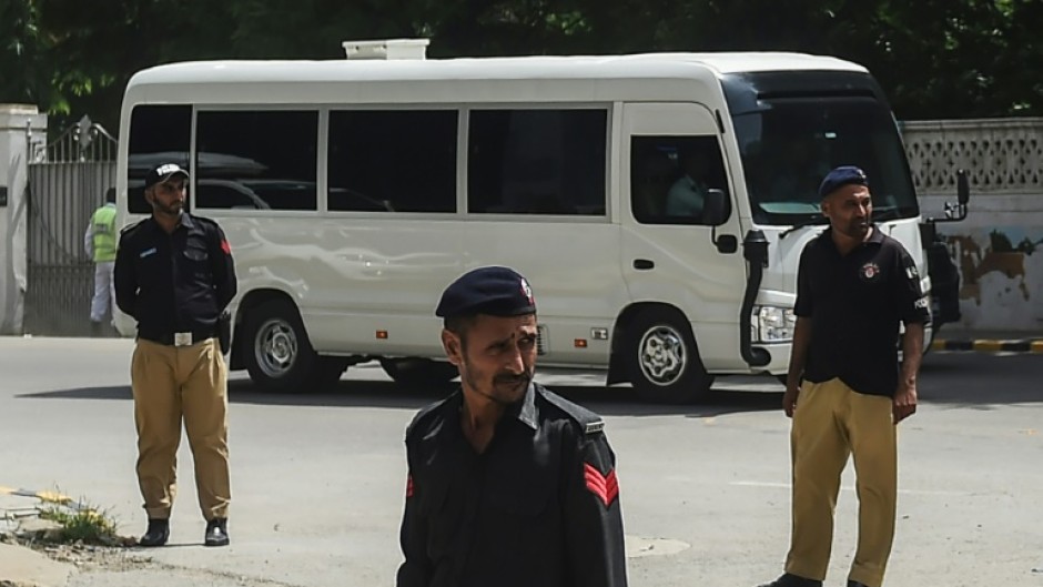 An England team bus drives past security in Karachi after their arrival for their first tour in 17 years