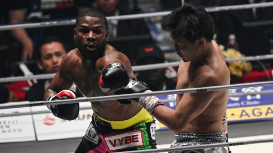 Floyd Mayweather (left) throws a punch at Japan's Mikuru Asakura during their exhibition fight in Saitama, Japan, on Sunday