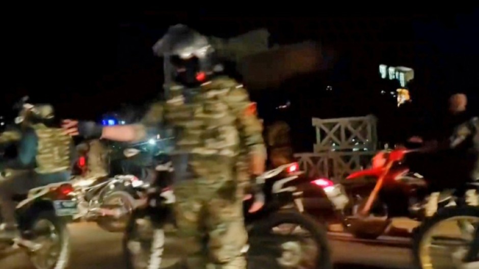 Iranians wave the national flag as they march during a pro-hijab rally in the capital Tehran on September 23, 2022