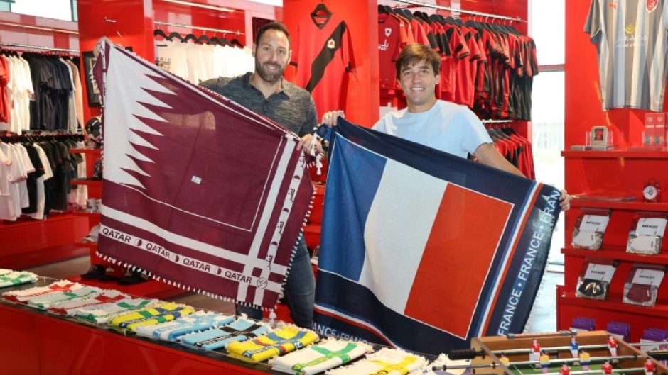 Bertrand Roine and Didier Grande are pictured with fan scarves they designed in the national colours of teams playing in the football World Cup
