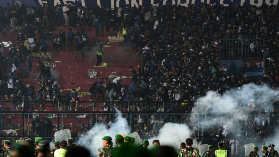 Police fired tear gas into packed stands