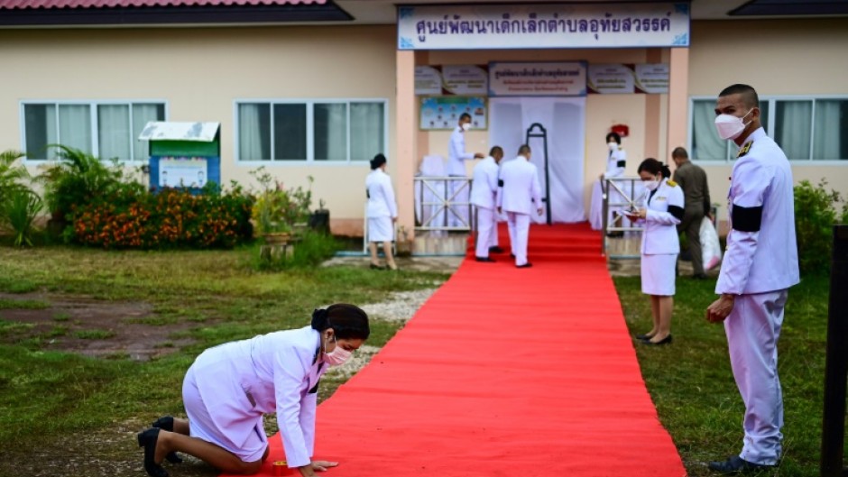 A red carpet installed around the nursery by officials before the royal wreath was laid was swiftly removed