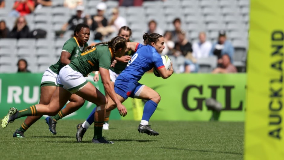 France's Laure Sansus runs the ball during their opening win