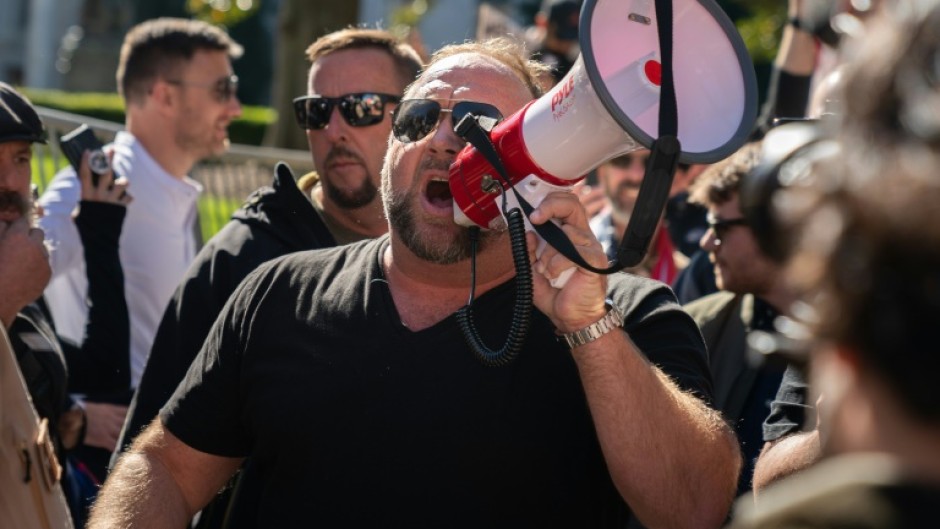 Alex Jones, at a November 2020 rally in Atlanta, Georgia, has been found liable in multiple defamation lawsuits brought by relatives of the victims of the Sandy Hook shooting