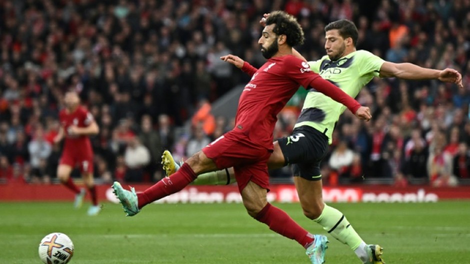 Liverpool match-winner Mohamed Salah (L) is challenged by Manchester City defender Ruben Dias.
