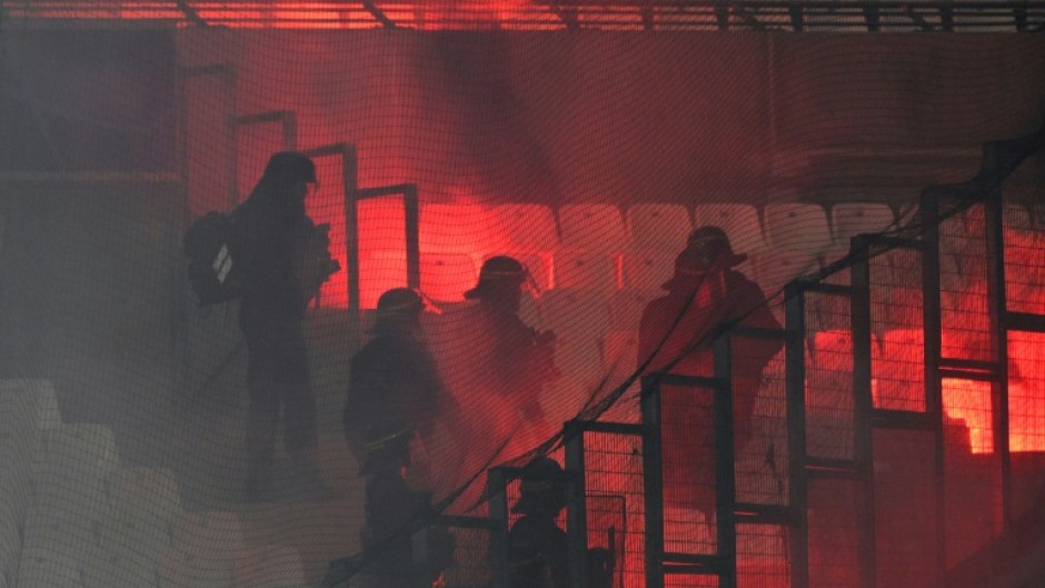 French riot police move in after flares were set off during the UEFA Champions League match between Marseille and Eintracht Frankfurt at Stade Velodrome 