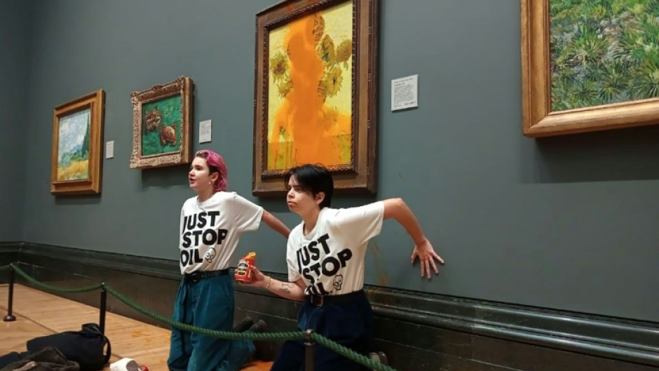 Two protesters hit Vincent van Gogh's 'Sunflowers' with tomato soup in London, but the painting was unharmed