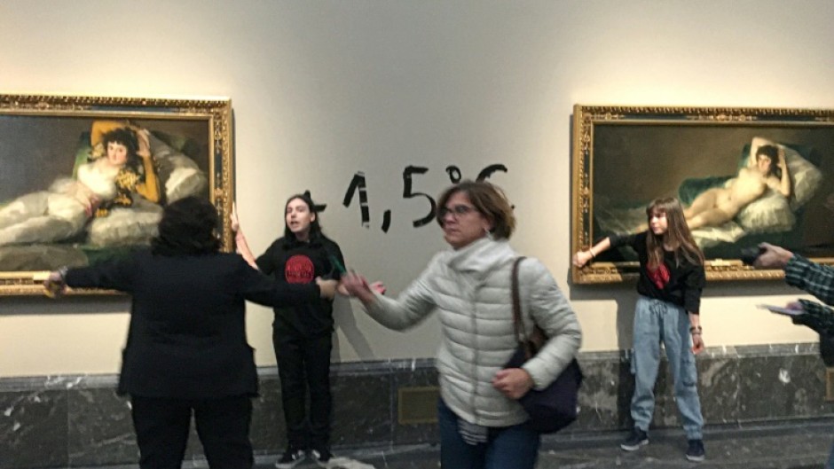 Two climate activists were detained after each glued a hand to a painting in the Madrid museum 