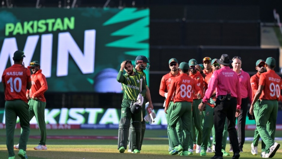 Pakistan's Shan Masood and Shadab Khan (C) walk off the field after their win over Bangladesh
