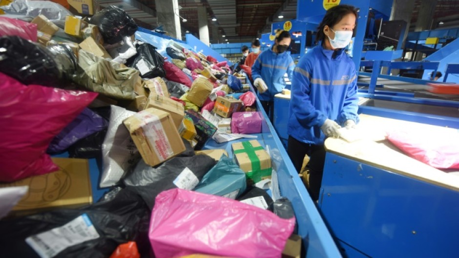 An employee sorts packages for delivery during the Singles Day shopping festival at a logistics center in Donghai, China
