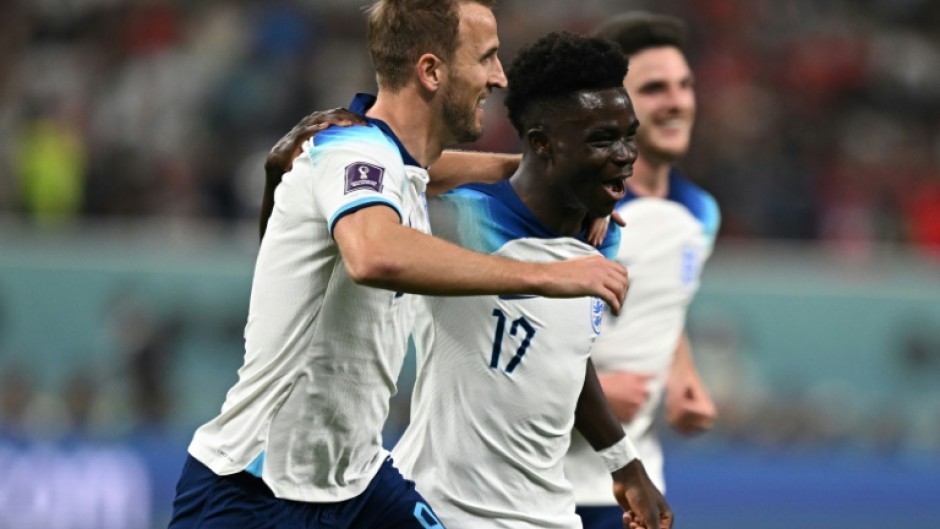 England's Bukayo Saka celebrates with Harry Kane