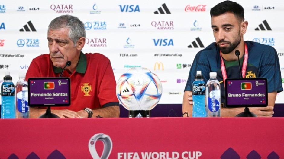 Portugal's coach Fernando Santos (L) and Portugal midfielder Bruno Fernandes hold a press conference