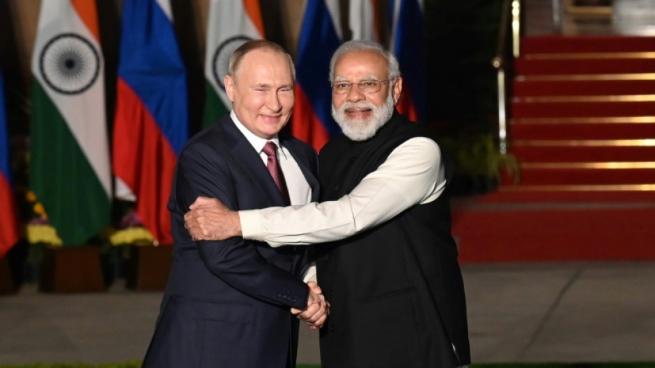 Indian Prime Minister Narendra Modi (R) greets Russian President Vladimir Putin before a late 2021 meeting in New Delhi
