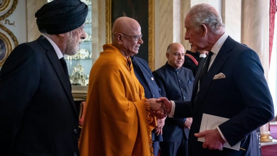 King Charles III (R) has described Britain as a 'community of communities'