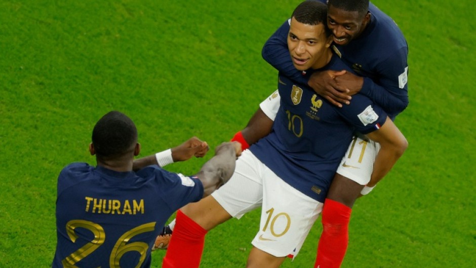 France's Kylian Mbappe (centre) celebrates after scoring the first of his two goals in a 3-1 last 16 win over Poland